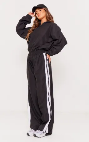 Black wide jumpsuit with zip and contrasting stripes.